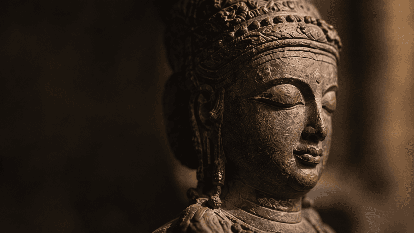 Carved stone figure in warm light